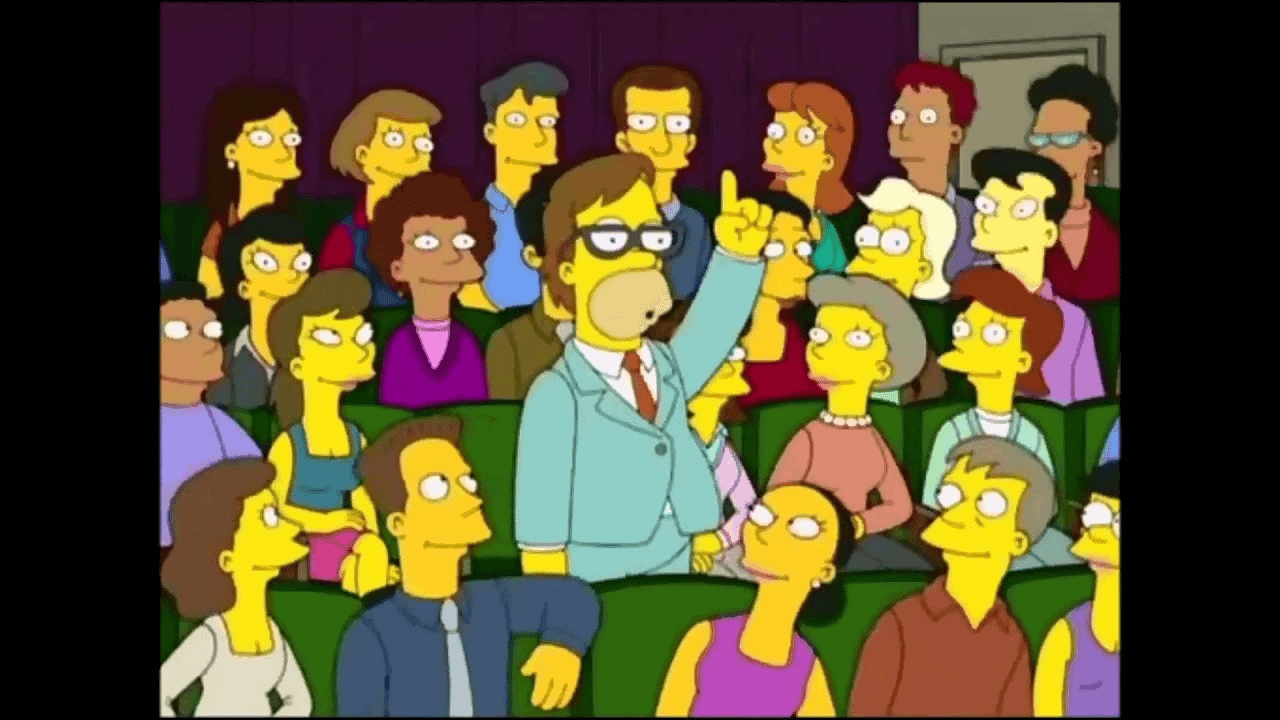 Man In Crowd Raises His Hand Eagerly