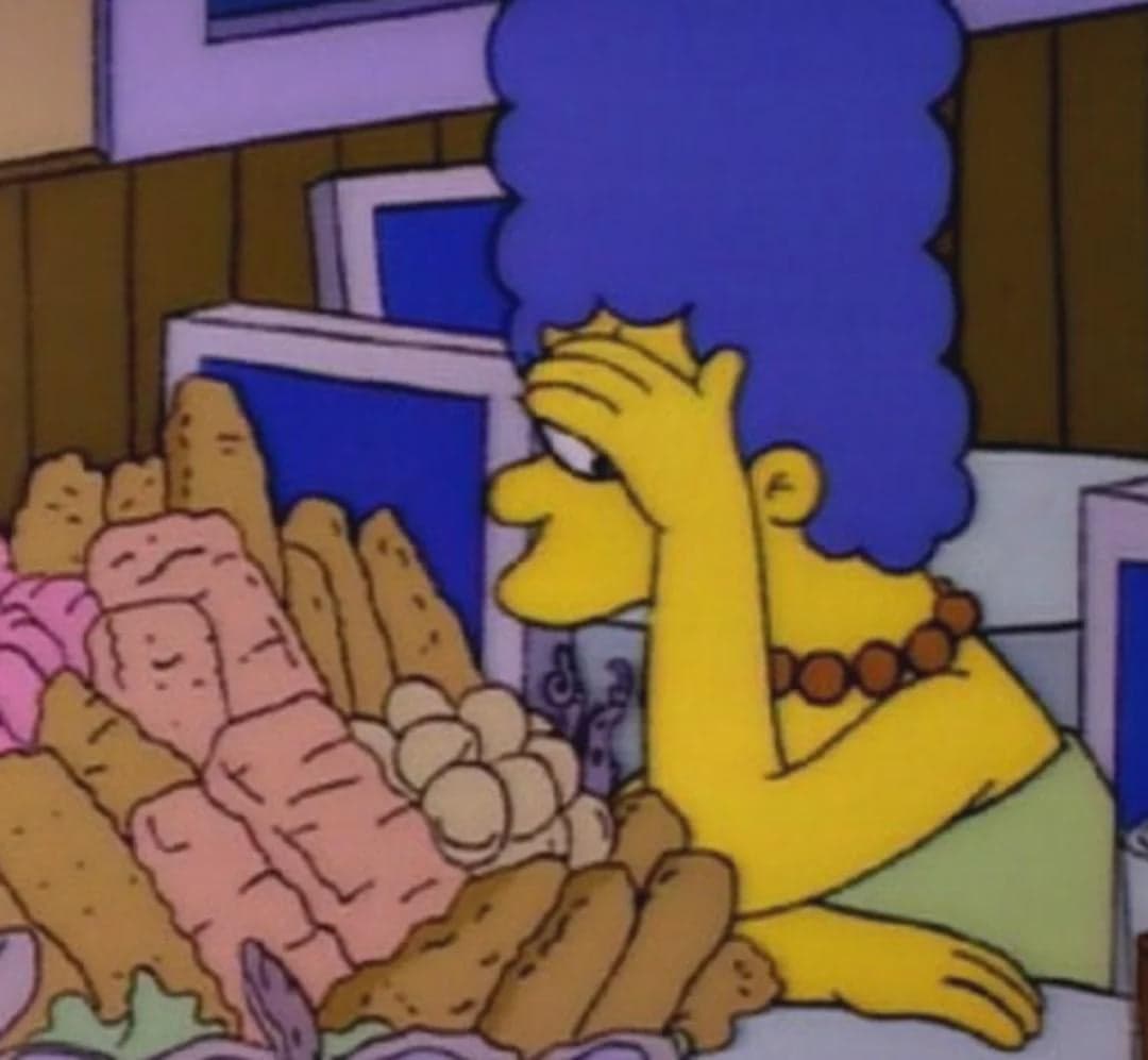 Marge Facepalms In Front Of A Food Mountain