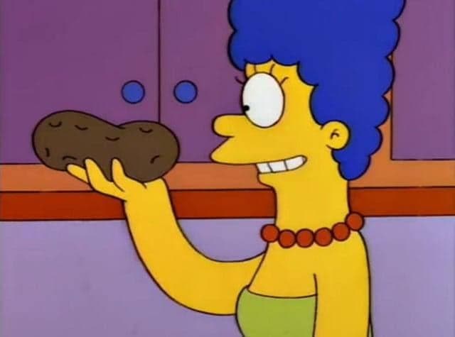 Marge Simpson Smiles While Holding A Potato